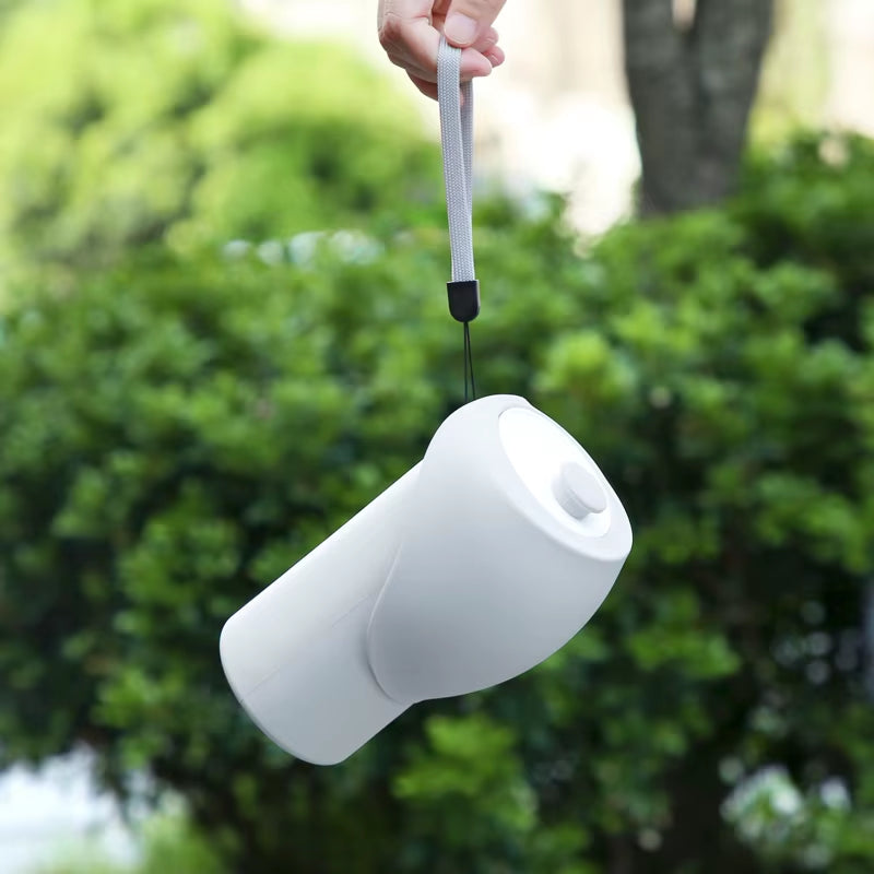 Bottle hanging upside-down by strap to show leak-proof seal.